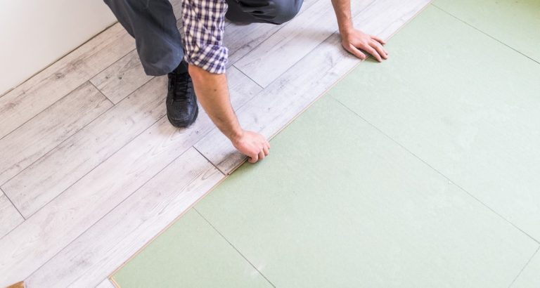 worker-processing-floor-with-bright-laminated-flooring-boards worker-processing-floor-with-bright-laminated-flooring-boards